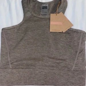 Träningstopp - Helt oanvänd tränings topp från stronger. Nypris 399. Den är beige/grå