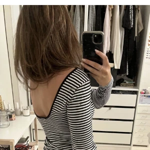 Tröja med öppen rygg - Superfin tröja med öppen rygg från H&M som är slutsåld! Säljer den på bilden och en som är vit med vinröda ränder. Säljer då de inte används, aldrig använda någon av dem! Lånad bild, 150kr+frakt per tröja. SVARTVITA SÅLD