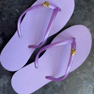 FlipFlops - Ljuslila FlipFlops inköpta  på Kuba. Aldrig använda. storlek ung 36-37 (märkta 35-36) Finns att hämta i Hornstull men kan också skicka 