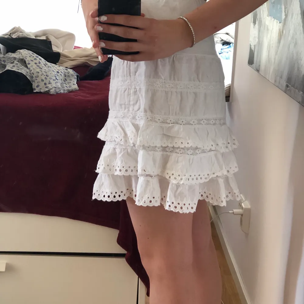 En fin vit volang kjol i spets som är så fin på och passar perfekt till sommaren. Fint skick och inga synliga defekter. Köparen står för frakten - 30 kr. Kjolar.
