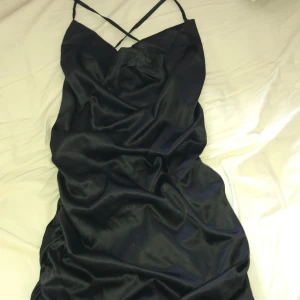 Siden klänning  - Tajt siden klänning med korsade band i ryggen 