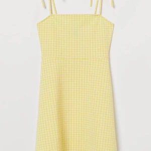 Gul rutig klänning  - Gul och vit rutig klänning med rosetter på axlarna. Kort. Aldrig använd. Frakt kan ändras 