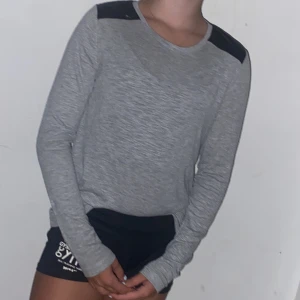 Långärmad tröja - En grå mjuk tröja med svart vid axlarna, gott skick och nästan aldrig använd