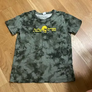 Militärgrön t-shirt med tryck från Lindex.  För pojkar. Storlek: 134/140