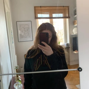 Svart NA-KD hoodie  - Svart NA-KD hoodie i storlek S med luva. Använt endast ett fåtal gånger. Tröjan har NA-KDs logga på framsidan i gult och rött. Kan posta men då står köparen för frakten ☺️