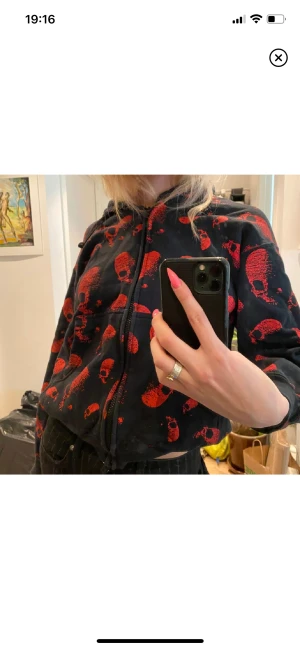 Dödskalle-hoodie - Säljer denna coola zip-up hoodie som inte längre kommer till användning. ”Tröjan” är svart med röda dödskallar och är i storlek Small. Bilden är från den tidigare ”ägaren” men önskas fler bilder på tröjan går det absolut att lösa!😇 köpt för 280❤️‍🔥