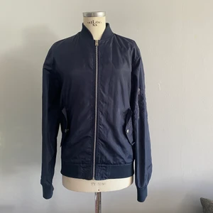 Jack & Jones Bomberjacka marinblå - Ofodrad bomberjacka med två fickor fram och en ficka på vänster arm. 