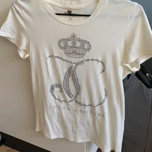 Juicy couture t-shirt - Säljer min fina juicy t-shirt som är i super fint skick. Endast använd fåtal gånger då den inte är min stil längre. Super fint tryck i rhinestones på framsidan. (Den är offwhite)