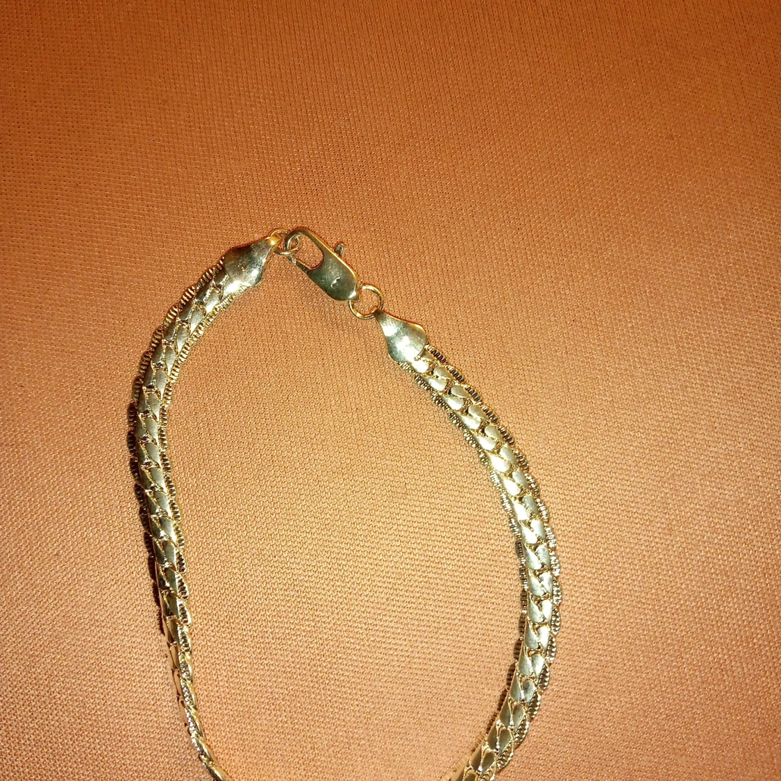 Armband silverfärgad mönstrad med lås .