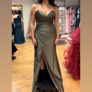 Balklänning / bröllopsklänning  - Så fin olivgrön finklänning. Perfekt till bröllop, bal eller finfest.   Använd några timmar. Den är uppsydd för att passa mig med klackar. Jag är 165cm. Köpt för 3500kr.  Skriv om du vill ha mina mått så kan jag självklart skicka det.