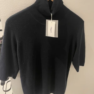 Filippa K merino - Helt oanvänd Filippa K Elbow sleeve i färg Navy, material merino. Ganska liten i storlek, passar nog både M och L.