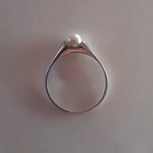 Ring i äkta silver med vit pärla. Mycket fin och i nyskick. Storlek 48 (1,8 cm i diameter) Ask: 10kr (valfritt) Frakt: 15 kr