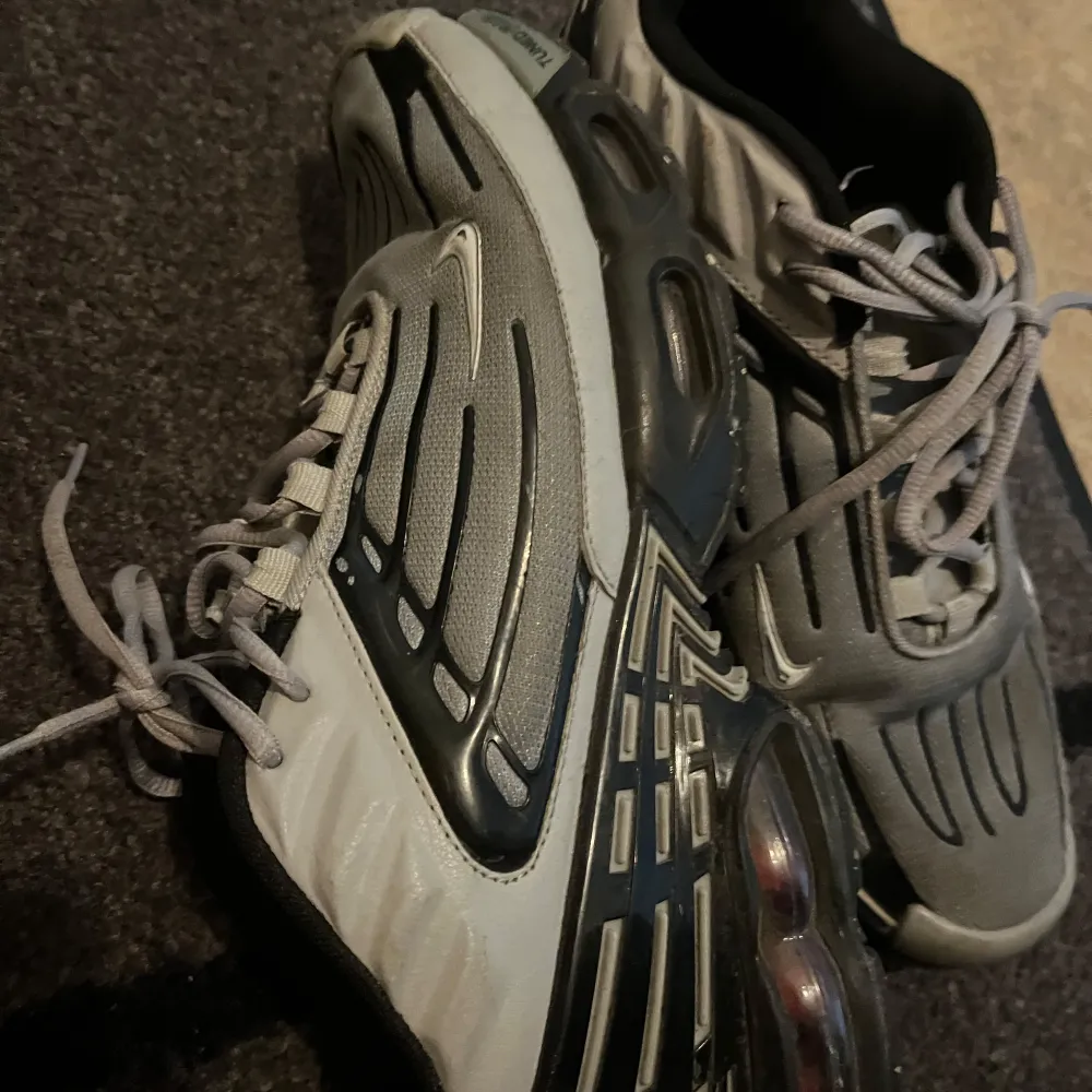 Säljer ett par Nike Air Max sneakers i grått med svarta detaljer. Skorna har en unik design med synlig Air Max-dämpning i sulan och snörning framtill. Perfekta för en sportig look. 45 men passar mer storlek 44.. Kengät.