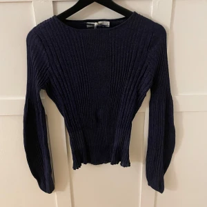 Mörkblå ribbad tröja - Blå glittrig långärmad tröja med vida ärmar.