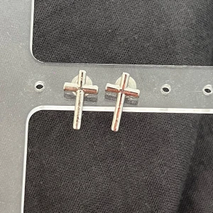 Silvriga korsörhängen - Ett par stilrena örhängen i form av kors i silverfärgad metall. Perfekta för dig som gillar minimalistiska smycken med en edgy vibe. Säljs som ett par och har klassisk stiftbaksida.