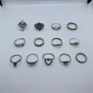 13 st  ringar -  13 st snygga silverfärgade ringar i olika former och mönster. 5 st har blå stenar. Storlek är 14mm - 18mm för att passa hela handen.