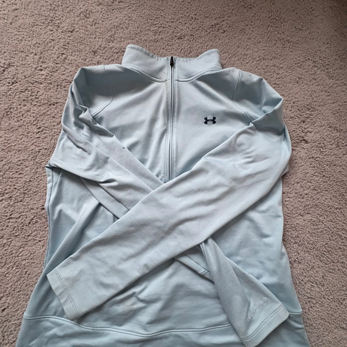 Ljusblå långärmad träningströja från Under Armour