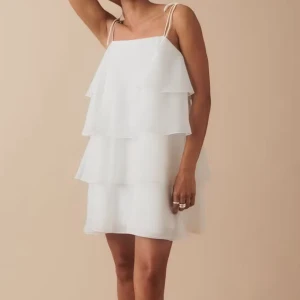 Vit volangklänning med smala axelband - Riktig snygg klänning som passar till skolavslutning, stunder eller konfirmation osv! Knappt använd och är som ny! Skriv om funderingar!💞