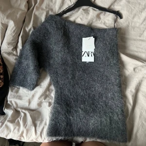 Asymmetrisk stickad topp i alpacka  - Prislappen är inte kvar. Har använt en gång. Liten i storleken så den sitter mer som en S . Super gosig. SLUTSÅLD på Zara