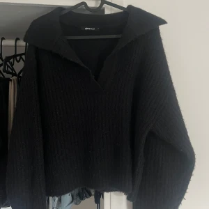 Svart stickad tröja från Gina Tricot - Mysig svart stickad tröja från Gina Tricot med v-ringning. Lite nopprig men inga andra defekter.