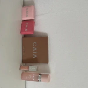 CAIA sminkset med palett & gloss - Säljer ett sminkset från CAIA med två rouge i rosa och persikoton, en face palette med contour, bronzer, blush och highlighter, samt ett skimrande ljusrosa läppglans. Allt i snygga förpackningar med spegel. Perfekt för dig som älskar fräscha och färgstarka looks.