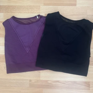 Mesh crop-toppar från Better Bodies - Två croppade mesh-toppar från Better Bodies, en i svart och en i lila. Båda är ärmlösa med transparent mesh över bröstet och logga nertill. Perfekta för gymmet eller träning, med tight passform och sportig look.