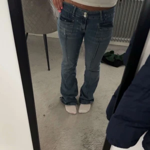 Blå bootcut jeans från Nelly - Snygga blå jeans från Nelly med bootcut passform och låg midja. Jeansen har fram- och bakfickor samt dubbla knappar i midjan. Vid funderingar eller intresse kontakta mig!😁