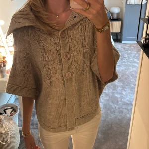 Beige stickad kofta med kabelstickning och stor krage - Stickad poncho perfekt för sommarkvällarna💕