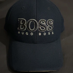Mörkblå keps från Hugo Boss - Hugo boss keps köpt från Johnells i Kista använd ett par gånger, kvitto finns också på den men behöver bara hitta den,