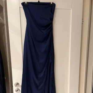 Marinblå balklänning från Nelly - Elegant marinblå axelbandslös balklänning från Nelly. Den är aldrig använd, prislappen är kvar! 💋