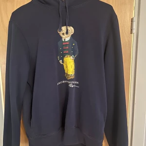Polo Bear hoodie från Ralph Lauren - Tja, jag säljer nu min riktigt schysta polo beat tröja från Ralph lauren eftersom den har börjat bli lite för liten. Tröjan är i ett bra skick och sitter väldigt bra. Modellen är 185cm så rekommenderar den till någon som är 170-180 beroende på vad man själv gillar. Hör av dig ifall du har några frågor eller vill ha fler bilder.                  MVH Alfred 