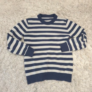 Randig blå, vit stickad tröja🌊⚓️ - Säljer en stilren blå och vit randig stickad tröja med rund halsringning och långa ärmar. Tröjan har ribbade muddar vid ärmslut och nederkant, perfekt för en avslappnad och snygg look, tröjan är i storlek S!