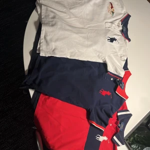 Pikétröjor från Polo Ralph Lauren i olika färger - Tre klassiska pikétröjor från Polo Ralph Lauren i färgerna vit, marinblå och röd. Alla har broderad logga och siffran 3 på ärmen, samt krage med kontrastfärgade detaljer. De är i storleken M (10-12) i barnstorlekar, men passar som S (man). Nypris: ca 1000kr/st och mitt pris är 190kr/ st. Men du kan också köpa alla för 439 (ca 250kr rabatt). Skriv bara vid minsta fråga, pris kan diskuteras!