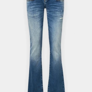 Blå bootcut jeans ltb - Snygga blå bootcut jeans med en lätt slitning för en trendig look. Perfekta för dig som gillar en klassisk stil med en modern twist. De har en låg midja och är tillverkade i jeansmaterial.