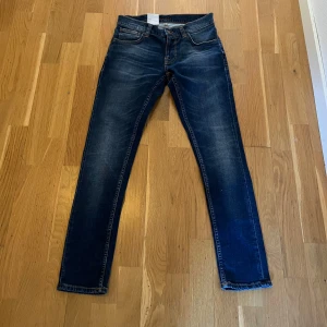 Nudie Jeans - Säljer ett par helt nya blåa jeans från Nudiejeans. Jeansen är slim passform och i modellen  tight terry, storleken är 30 I length och 30 i waist. Det är helt ny skick och alla tags finns kvar. Pris kan diskuteras.