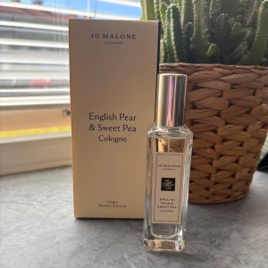 Jo Malone English Pear & Sweet Pea - Fräsch och elegant parfym från Jo Malone, English Pear & Sweet Pea Cologne. Kommer i en stilren, transparent glasflaska med silvrig kork och beige etikett. Förpackningen är ljusbeige och minimalistisk. Volymen är 30 ml. Ny 