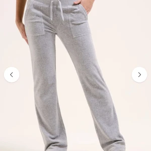 Grå mjukisbyxor Juicy Couture XXS - Grå mjukisbyxor från Juicy Couture med raka ben, bred resår i midjan och snörning. Byxorna har stora fickor framtill och en bakficka med knappdetalj. Supermjuka och perfekta för chill dagar.