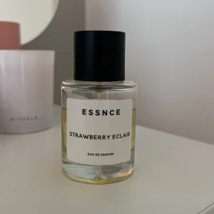 ESSNCE Strawberry Eclair parfym - ESSNCE Strawberry Eclair Eau de Parfum i en stilren, rund glasflaska med svart lock. Doften har inslag av jordgubb och bakverk, perfekt för dig som gillar söta och fruktiga toner. Mängd enligt bild.