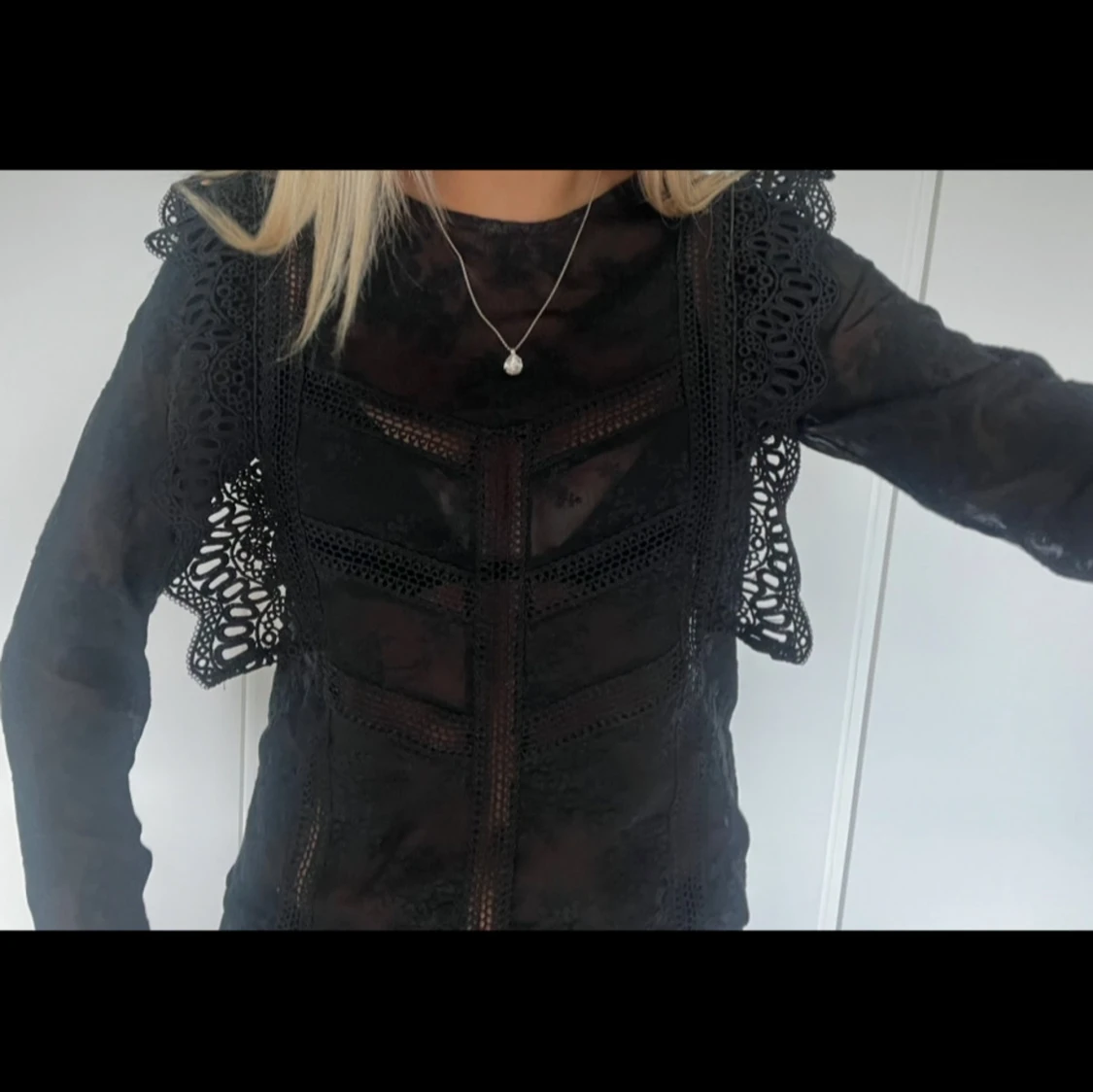 Svart spetsblus med volangdetaljer - 1