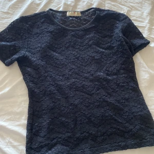 Svart spetsblus från Glu-Glu - Skriv för tydligare bilder på! 💓Säljer en svart blus från Glu-Glu med korta ärmar och rund hals. Hela toppen är täckt av snygg spets med vågigt mönster som ger en cool och feminin vibe. Perfekt för dig som gillar detaljer och vill sticka ut lite extra.