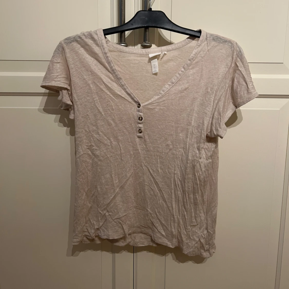 Beige linnetopp med knappar från H&M