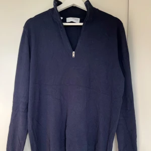 Halv Zip tröja - Säljer en marinblå half zip tröja från Selected Homme. Tröjan har långa ärmar och är perfekt för en stilren look💪 Finns ett litet hål vid nederdelen av baksidan men som knappt syns. Vid frågor eller funderingar tveka inte på att höra av er🤝