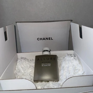 Chanel Allure Homme Édition Blanche 100ml - Chanel Allure Homme Édition Blanche Eau de Parfum 100ml med ca 50ml kvar. Flaskan är stilren i matt silverfärg med svart text och har en rundad fyrkantig form. Korken är silver med en metallisk ring där det står Chanel. Kommer i originalkartong med vitt silkespapper. Originalpris 1797kr för 100ml, originalpris 1273kr för 50ml. 