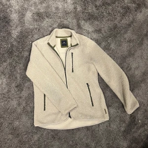 Beige fleecejacka från Hansen & Jacob - Tjena, säljer en skit skön å snygg zip tröja/fleece från hansen & jacob. Tröjan påminner om Patagonia fleecen i looken men bättre kvalite. Den spontan köptes för några månader sen men märkte ganska snabbt att den inte riktigt är min stil. Den är med andra ord nästan aldrig använd. Nypris: 2000kr. Storlek: L. 