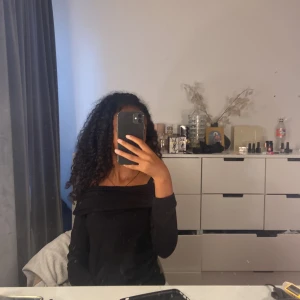 Svart offshoulder tröja Gina Tricot - Svart långärmad offshoulder tröja från Gina Tricot. Snygg och enkel modell med bred krage som sitter snyggt över axlarna. Perfekt att styla med jeans eller kjol för en clean look.