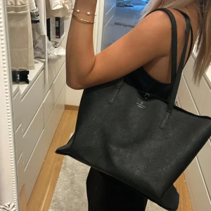 Svart axelväska - Säljer min svarta väska som passar till allt! Rymmer mycket och har ett stort fack alltså inga små !