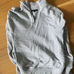 Ljusgrå zip tröja - Säljer en ljusgrå halvzip tröja. Bra skick inga defekter, stilren och skön. Passar S/M