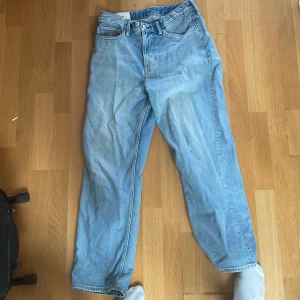 Ljusblå loose fit jeans från H&M - Säljer ett par ljusblå loose fit jeans från H&M i klassisk denim. Perfekt för dig som gillar en avslappnad och trendig stil. Storlek 30/32.