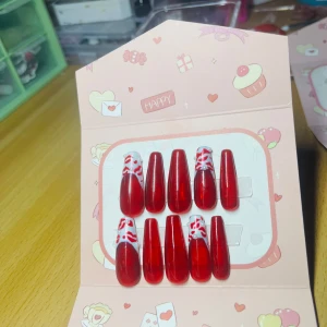 Cherry kissed -  "Cherry Kissed Nails: A vibrant cherry red polish adorns these gorgeous nails, with a chic twist on the thumb and ring finger featuring elegant French tips and a playful kiss mark 💋 design. The other fingers showcase a simple, yet striking, cherry red hue."
