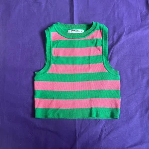 Randig croptop  - Starka färger i rosa och grön. Stickat tyg, mycket stretchig. 80% viskos, 20%polyamid Knappt använd.